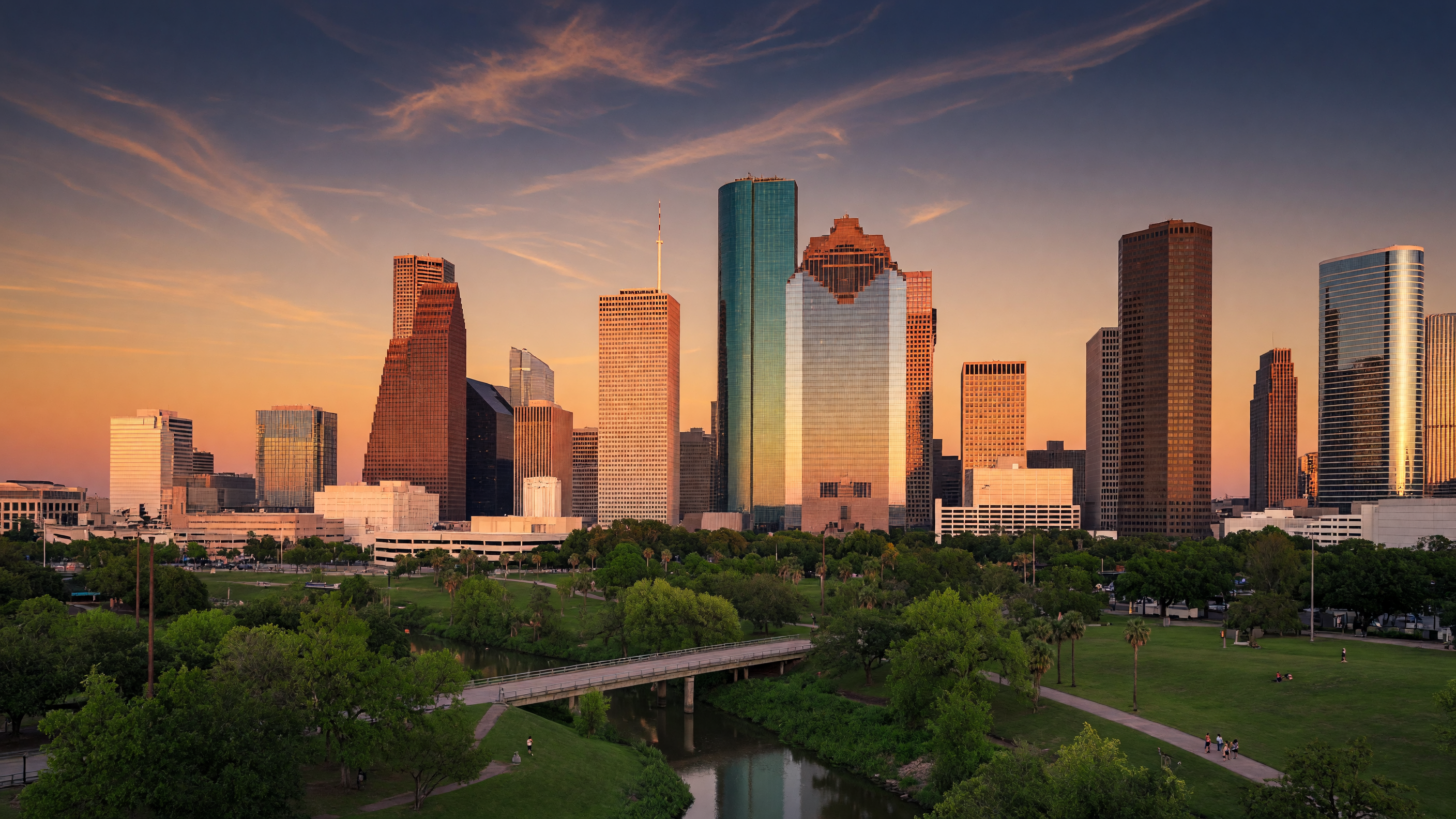 Houston, Texas skyline at golden hour with downtown skyscrapers reflecting warm sunlight