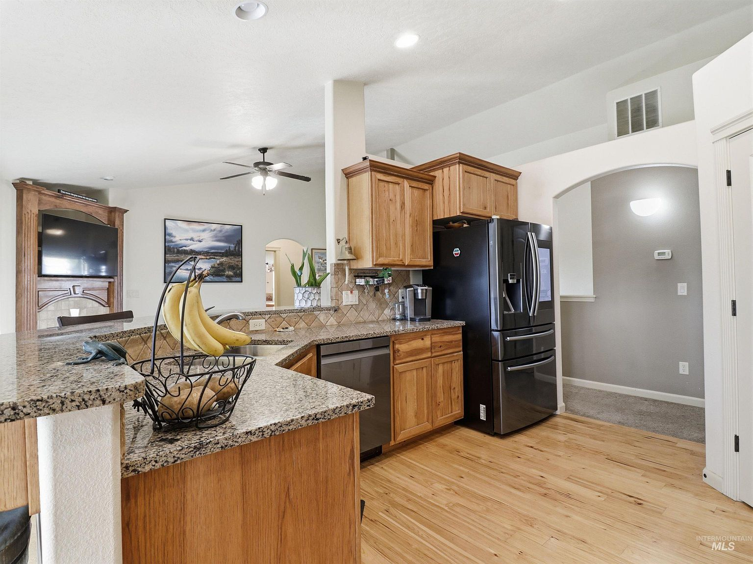 Kitchen with natural oak cabinetry and granite countertops