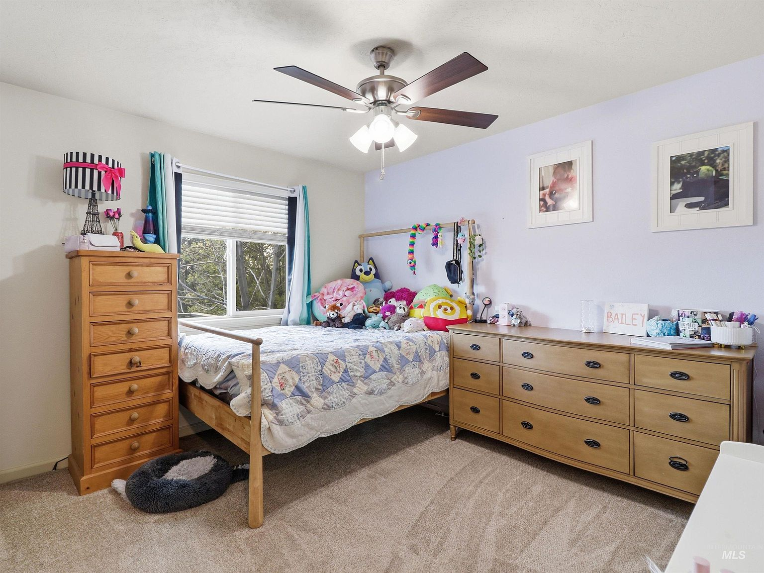 Secondary bedroom with light purple accent wall
