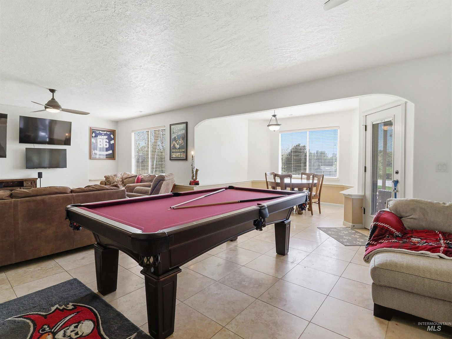 Recreation room with pool table and multiple seating areas