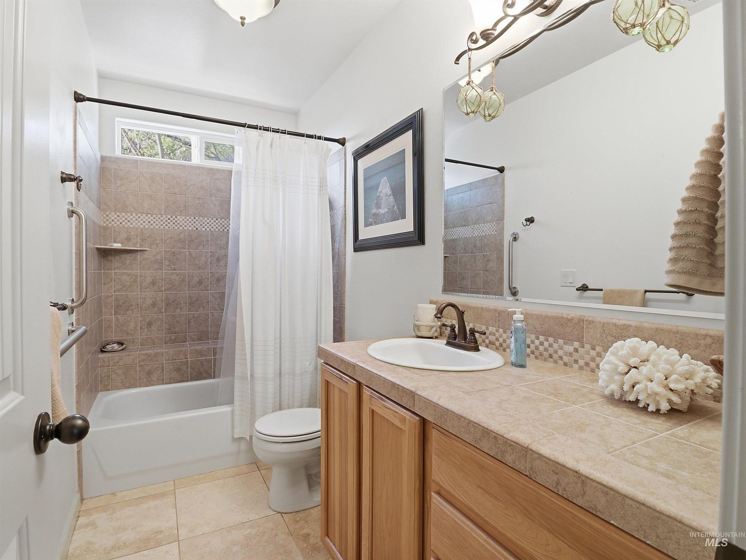 Third bathroom with tiled vanity and oil-rubbed bronze fixtures