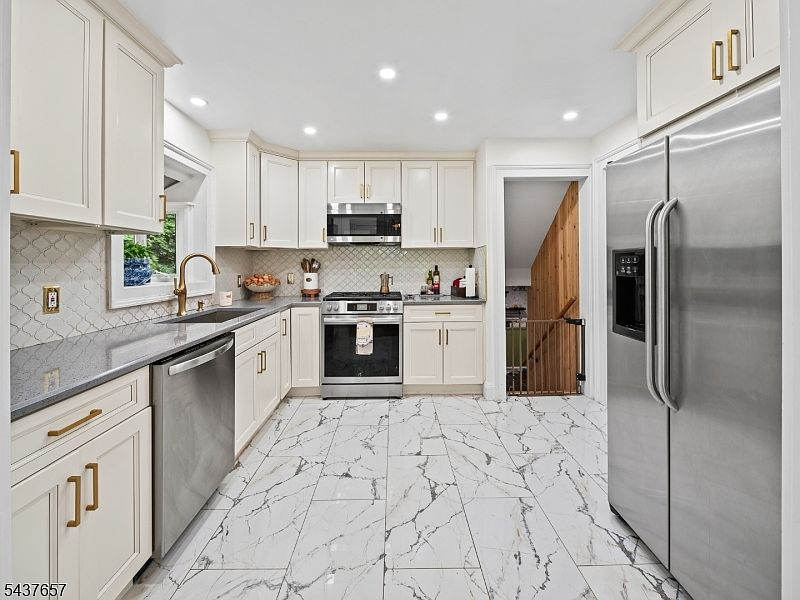 Renovated white kitchen with stone counters at 17 Ravine Ct Clifton NJ