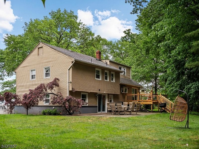 Backyard at 17 Ravine Ct Clifton NJ with deck patio lawn and mature trees