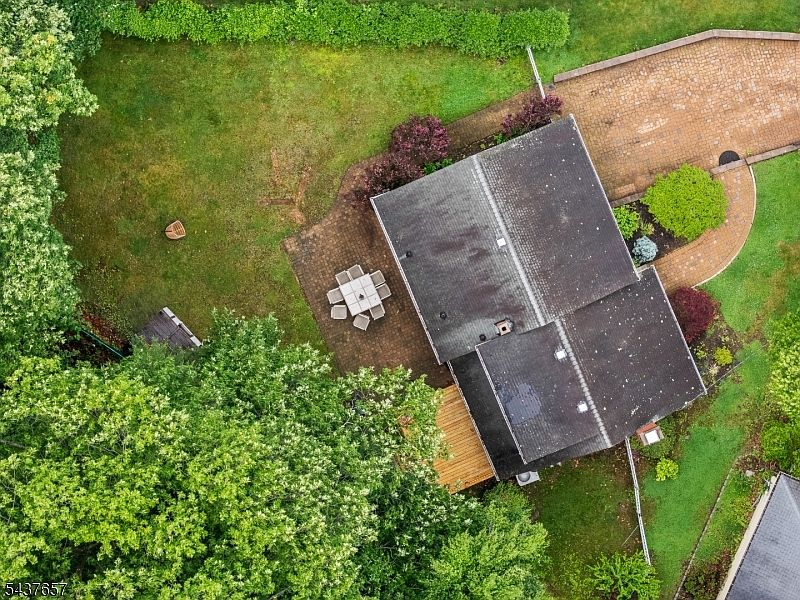 Drone view of backyard backing to ravine with walking trail