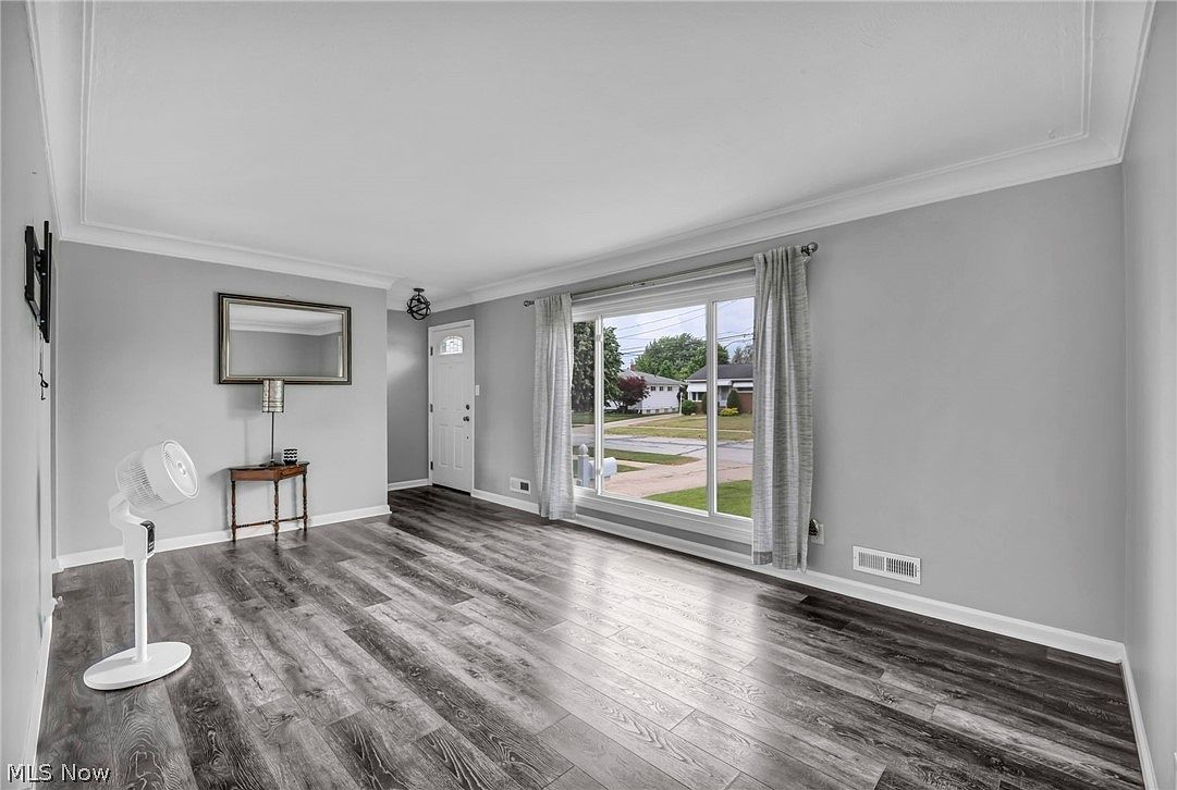 Living room looking toward the front entry with grey luxury vinyl plank flooring