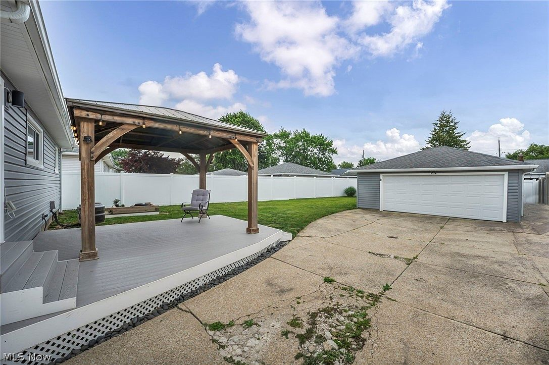 Backyard with wooden pergola and outdoor living area