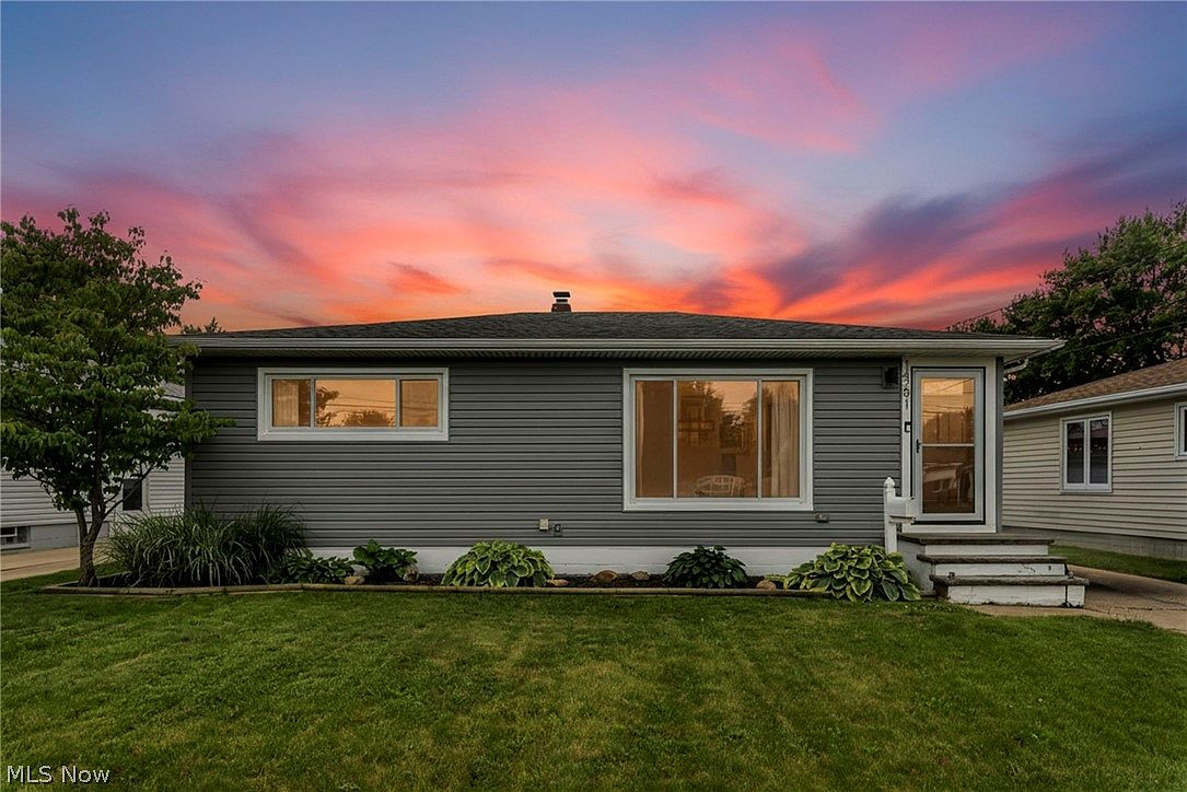 Exterior facade at golden hour with dramatic pink and orange sky