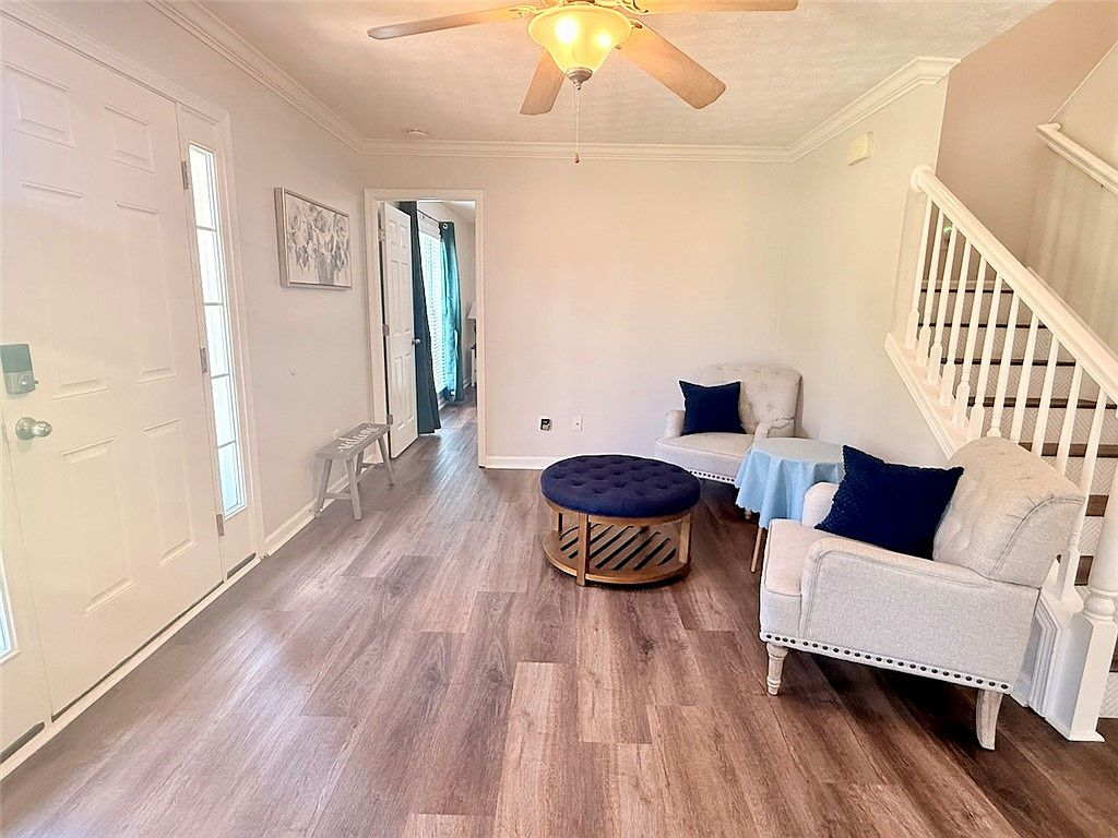Entry foyer and living area with wood-look flooring