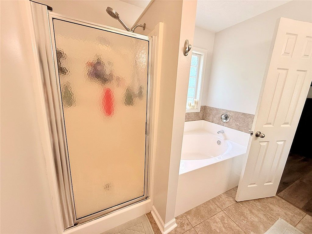 Primary bathroom with separate shower stall and garden tub