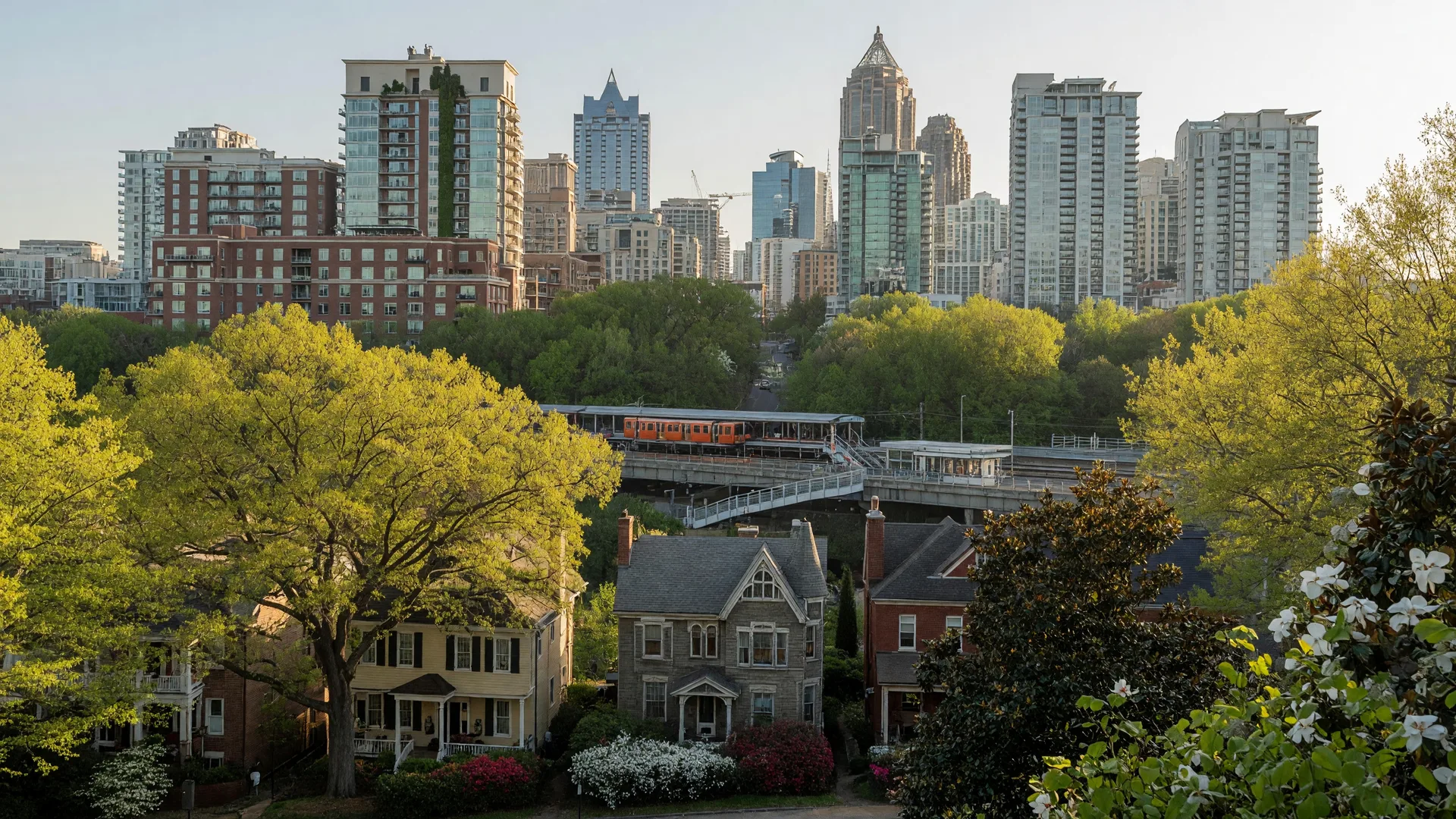 Midtown Atlanta skyline seen from Piedmont Park with tree-lined residential streets in the foreground