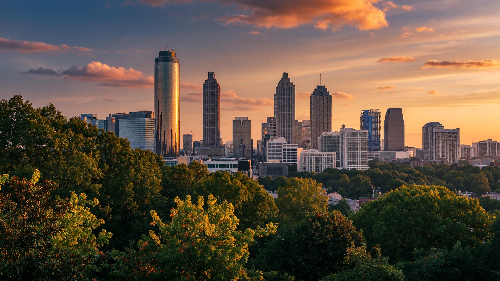 Atlanta Midtown and Downtown skyline at golden hour, framed by the city's signature tree canopy