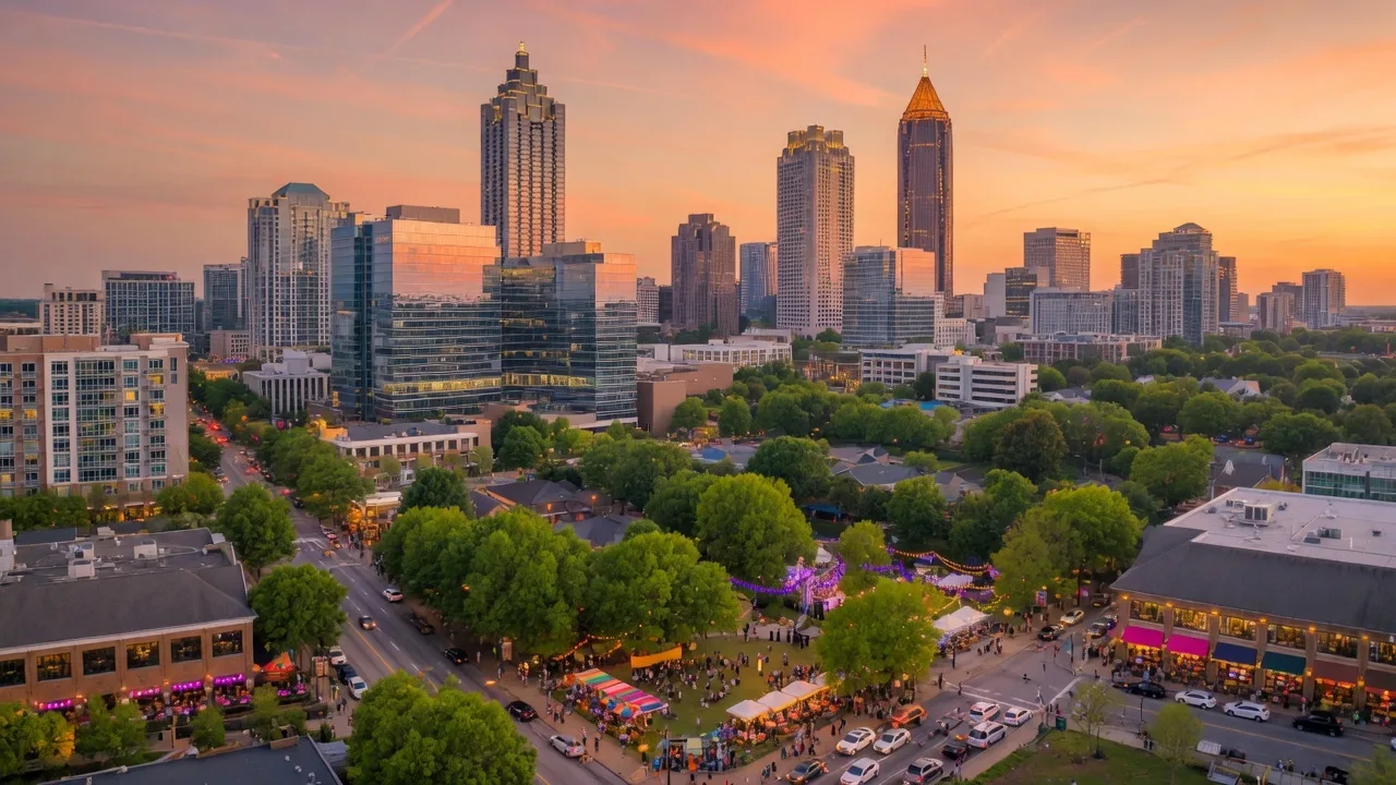 Vibrant Atlanta cityscape at golden hour with the skyline, tree canopy, and bustling street-level energy