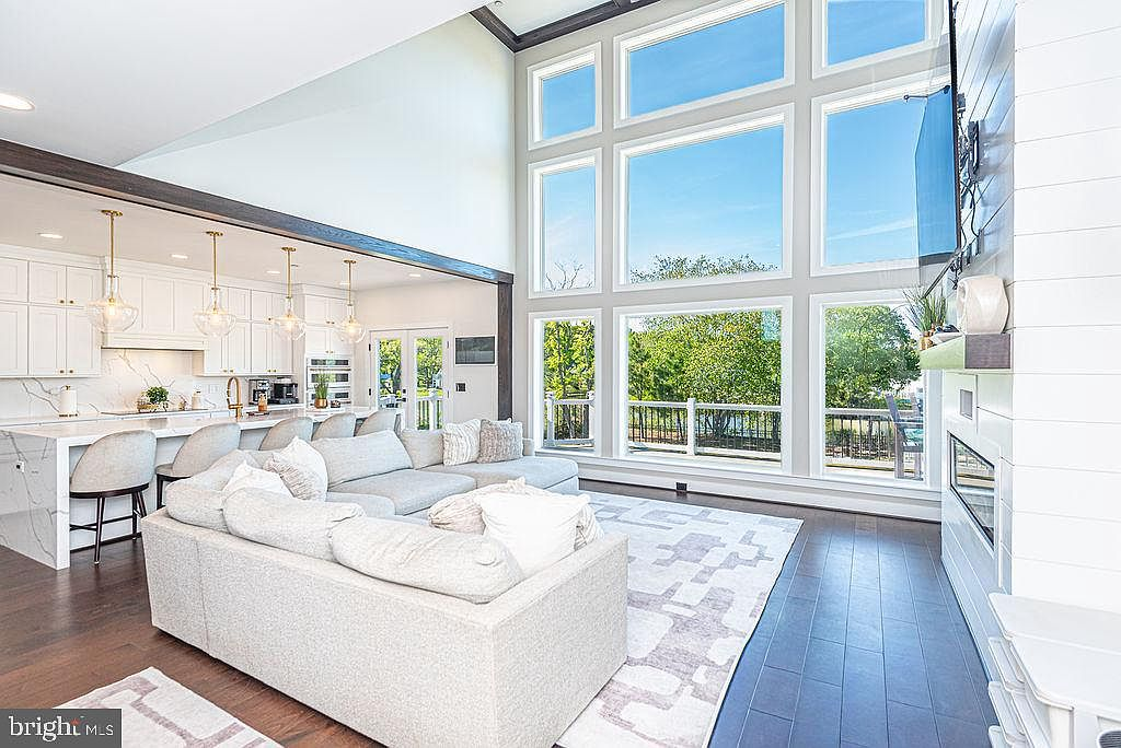Two-story living room with floor-to-ceiling windows and bay views