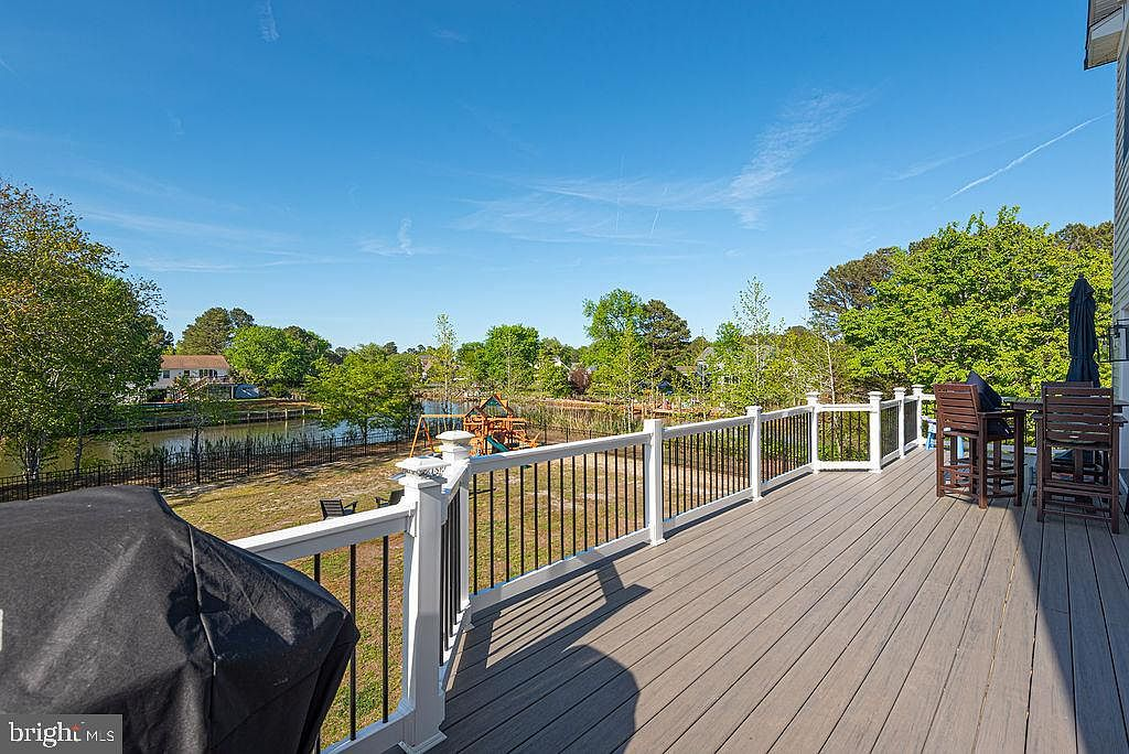 Composite deck overlooking the fenced backyard and canal