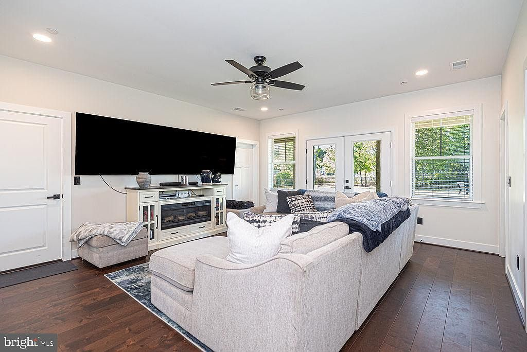 Ground-level recreation room with sectional and French doors