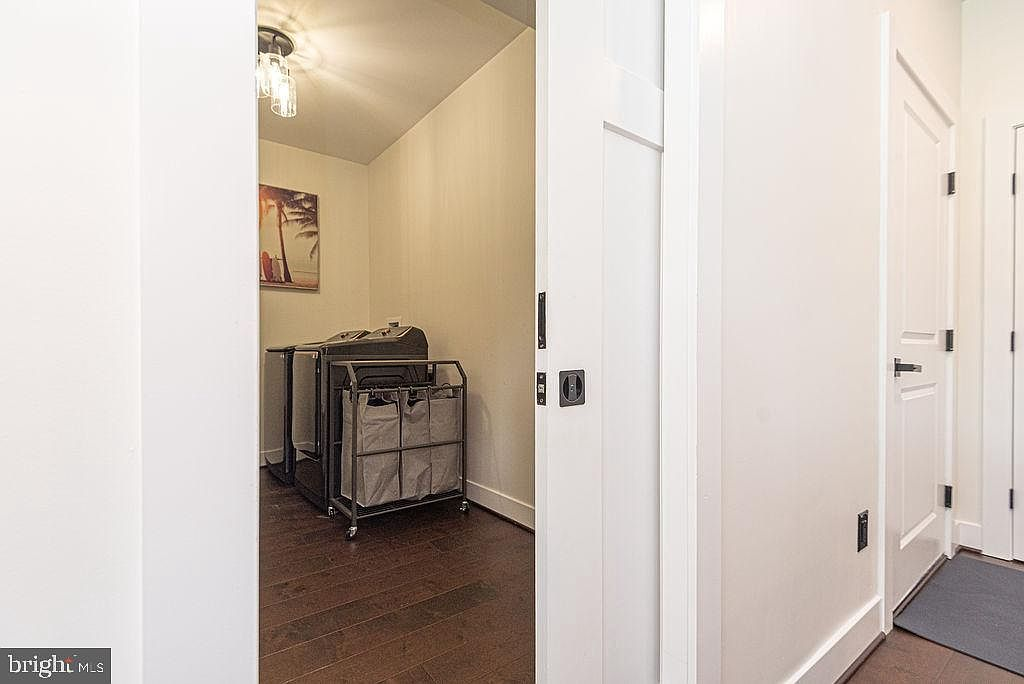 Mudroom and laundry with barn door and dark hardwood floors
