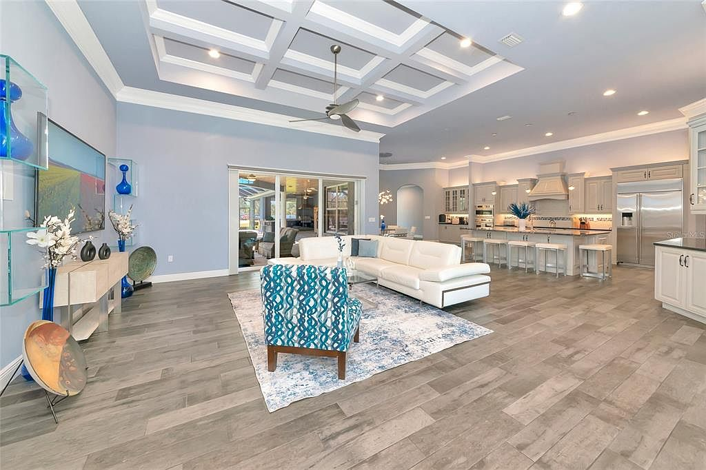 Open-concept living room and kitchen with coffered ceilings