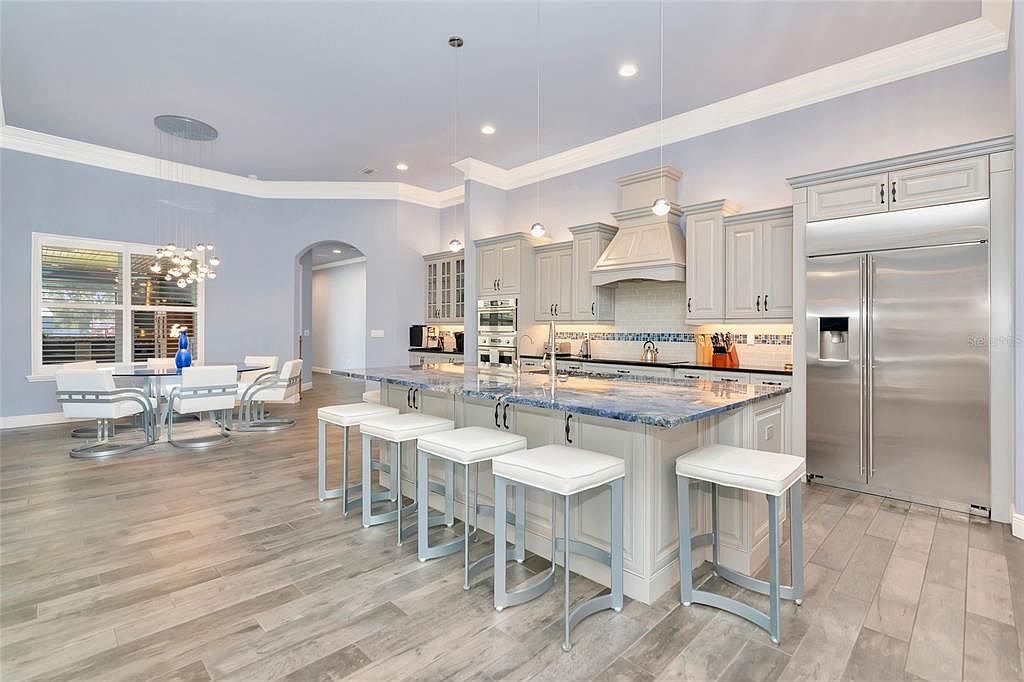 Chef-inspired kitchen with blue granite island and grey cabinetry