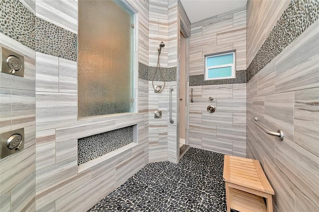 Walk-in shower finished in marble with rainfall head and wall jets