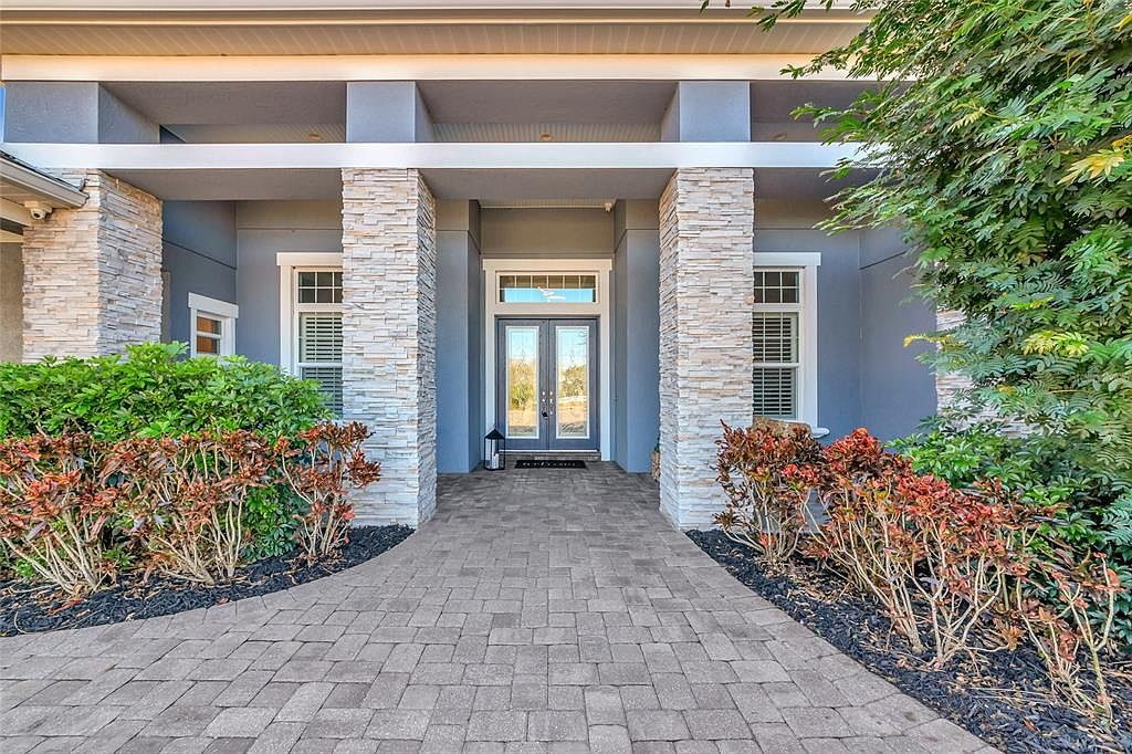 Primary entry framed by stacked stone pillars