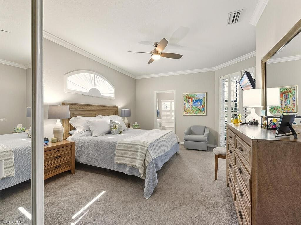 Master bedroom with neutral carpet and natural light