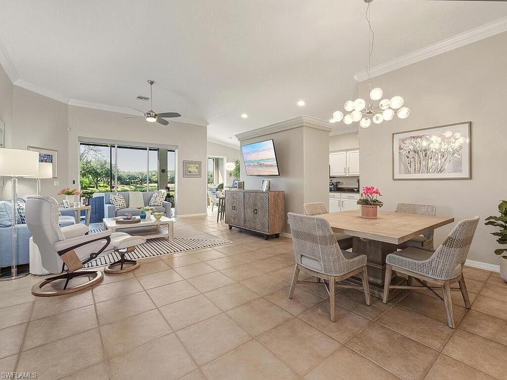 Open-plan living and dining area with natural light from sliding glass doors