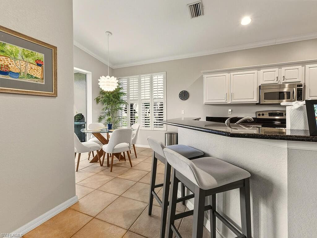 Kitchen peninsula and breakfast nook with plantation shutters