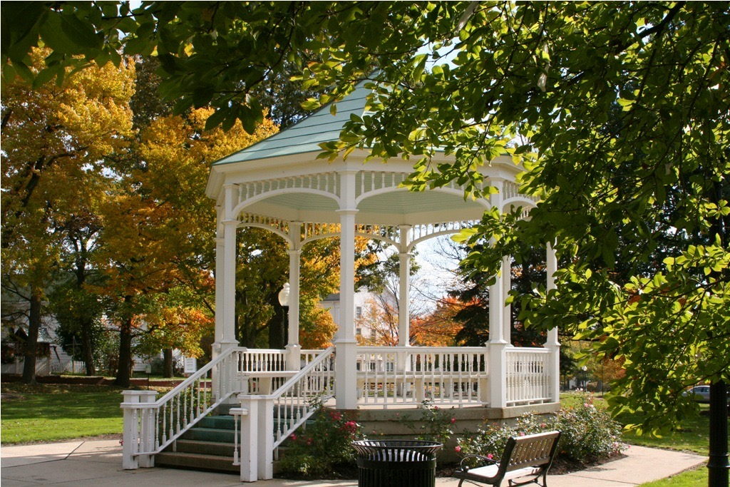 A classic white gazebo in a community park with autumn foliage in Geauga County