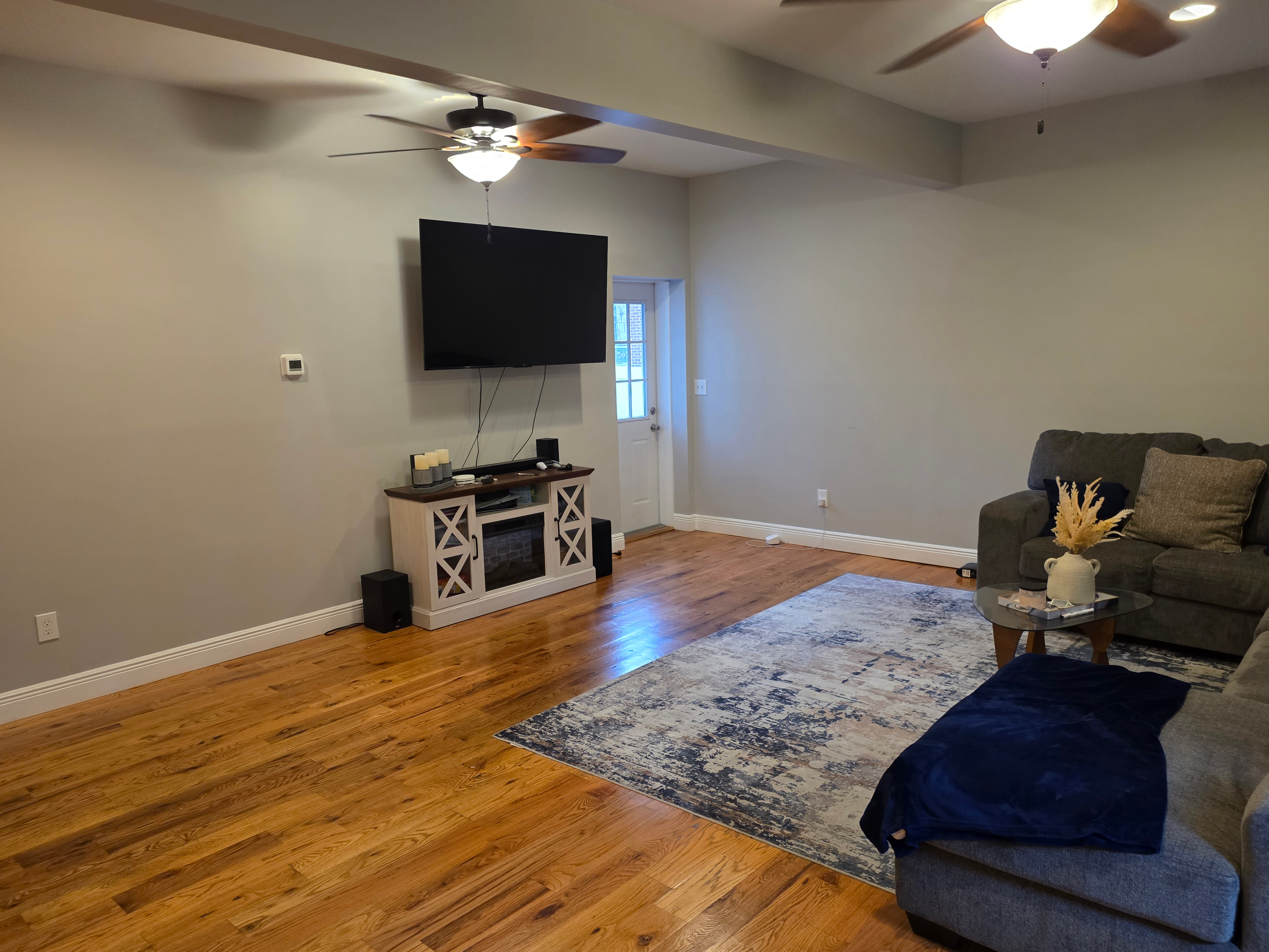 Living room view with hardwood floors and ceiling fans