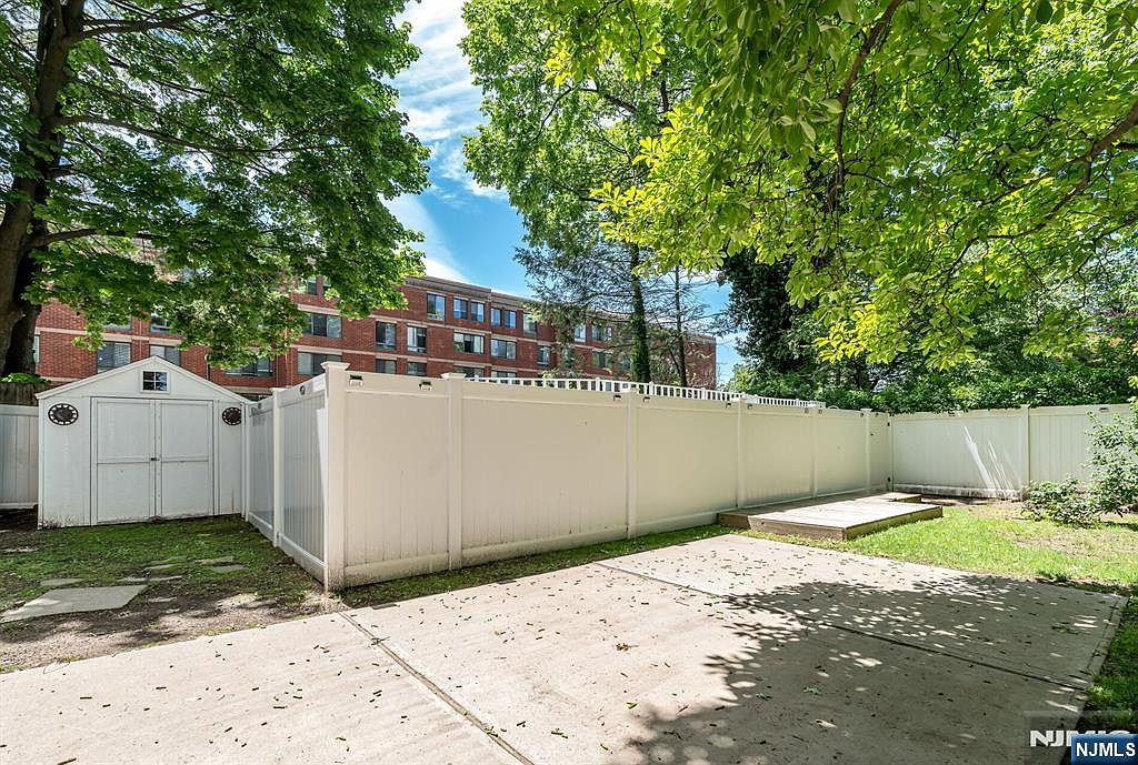 Private fenced backyard with concrete patio