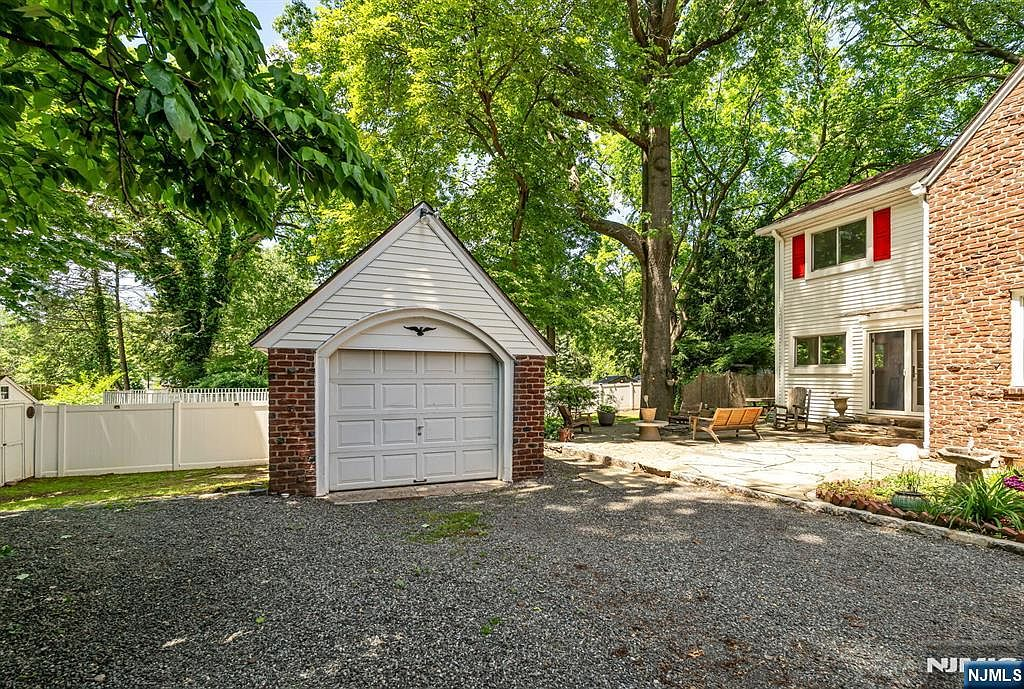 Detached brick garage and stone patio
