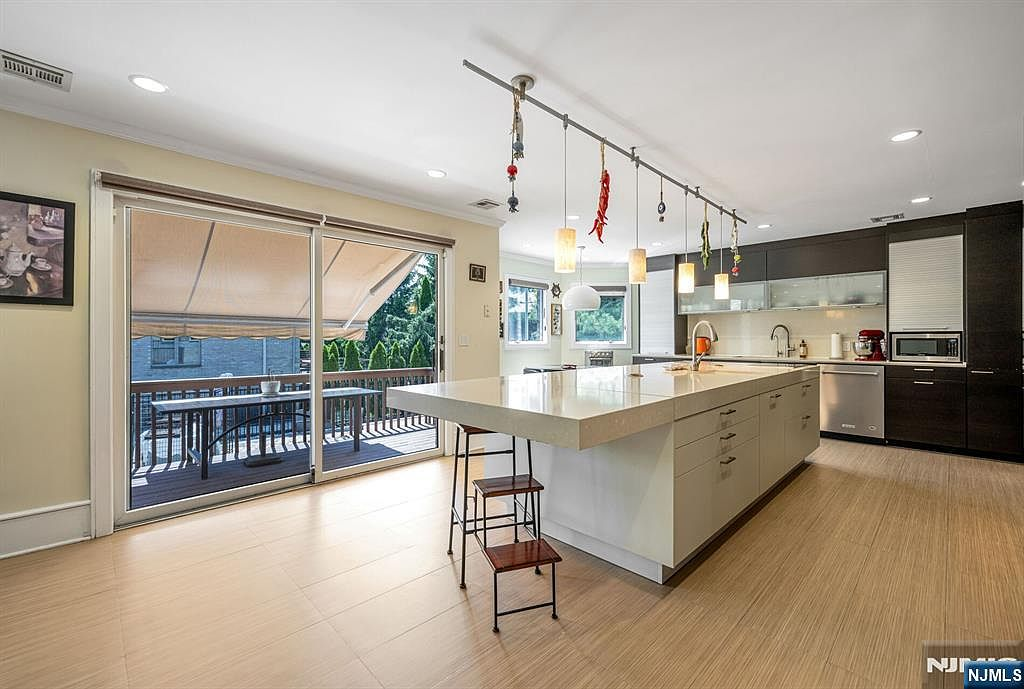 Kitchen island with natural daylight from slider to deck