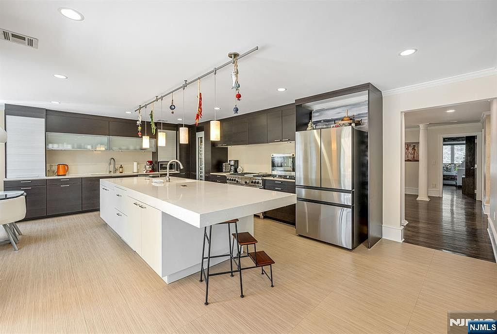 Chef's kitchen with Poggenpohl Wenge cabinetry and white quartz waterfall island