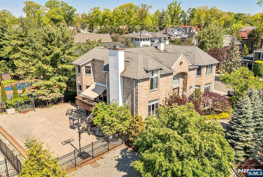 Aerial view of rear and side elevation showing deck and patio