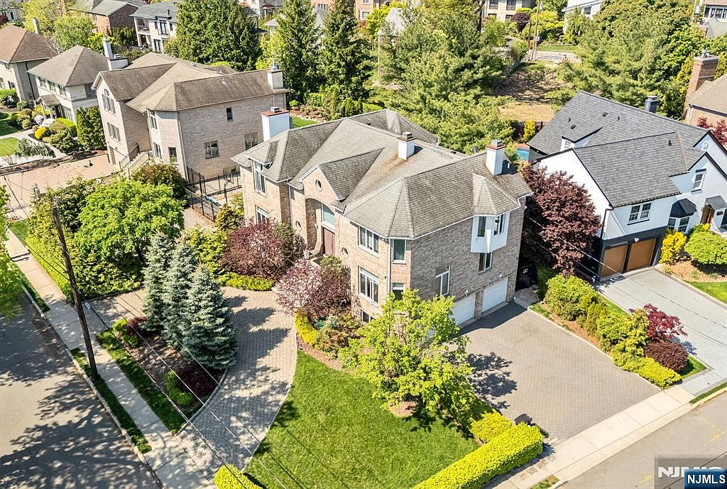 Aerial of corner lot with three-car garage and mature landscaping