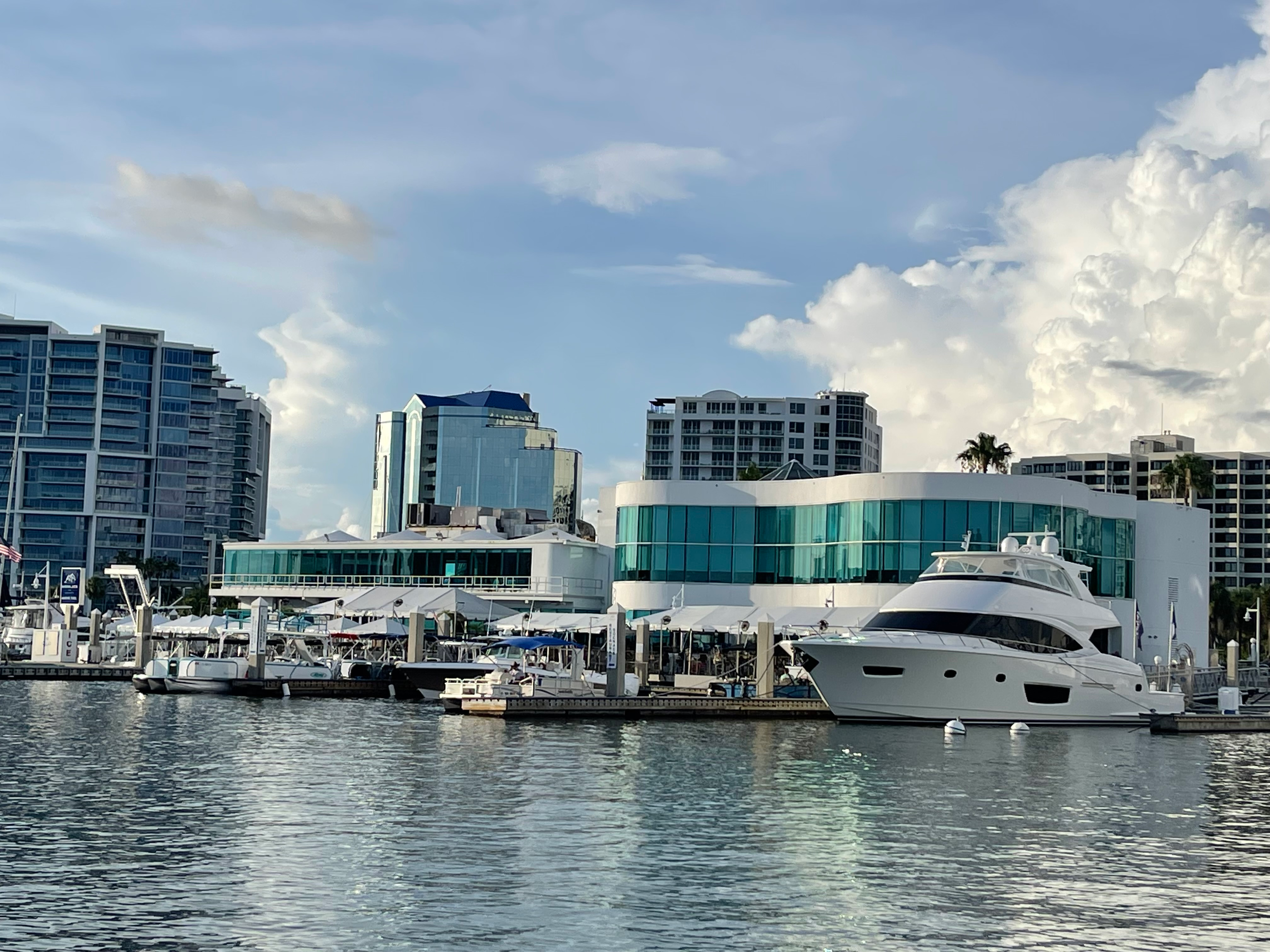 Marina Jack's yacht harbor on Sarasota Bay with boats docked along the waterfront and downtown Sarasota in the background