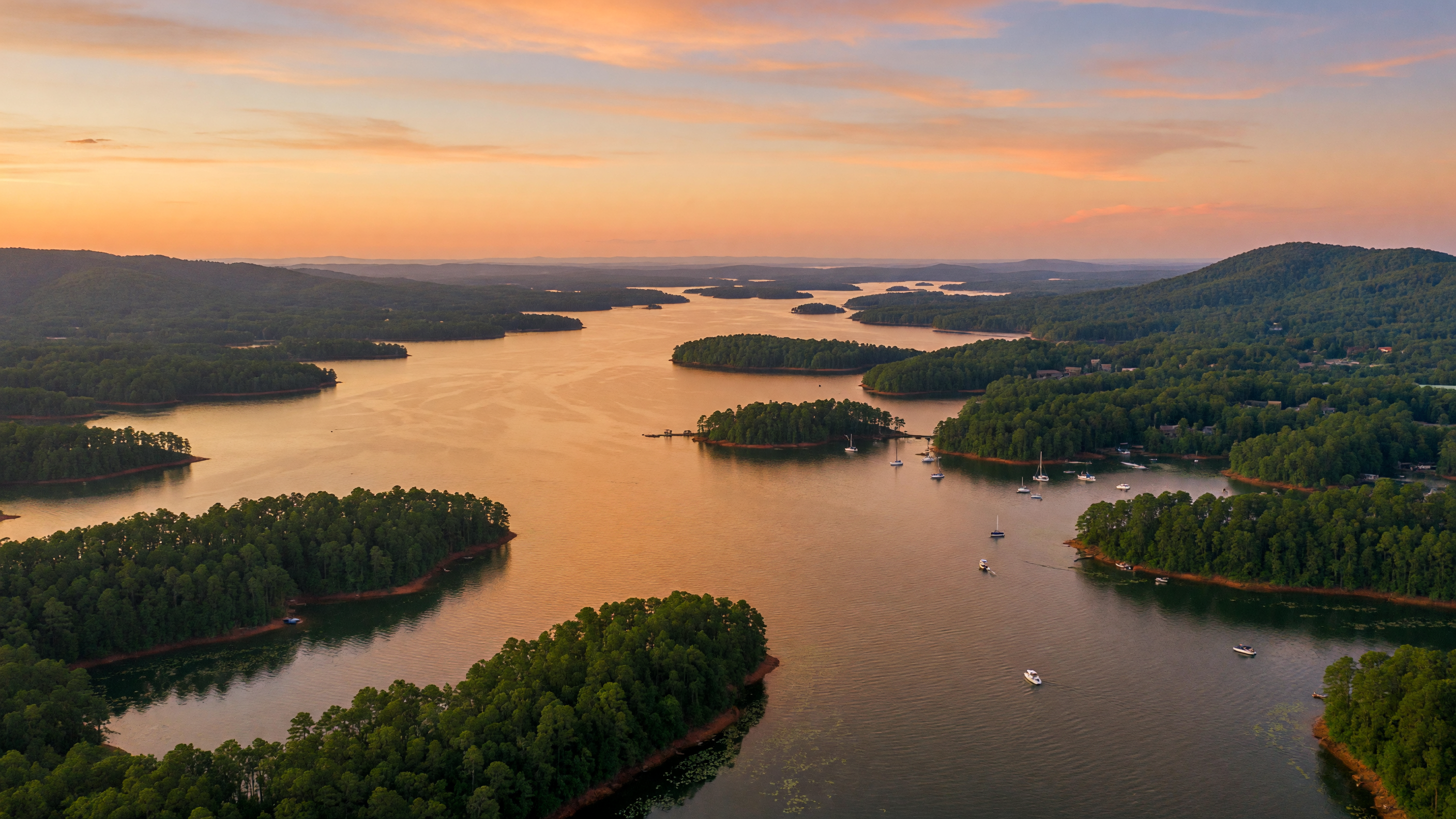 Pontoon boat on calm Lake Murray water surrounded by wooded shoreline on a sunny summer day