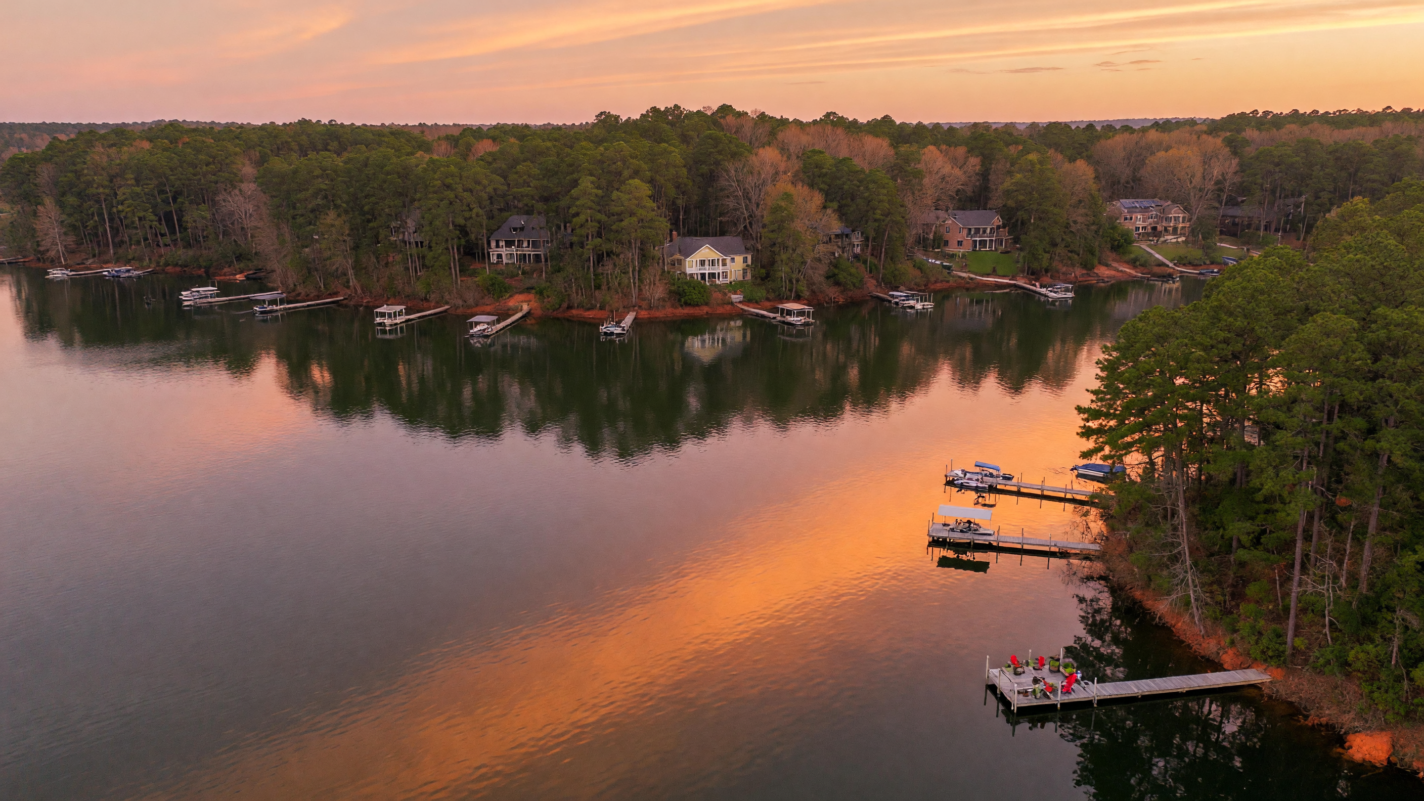 Lake Murray shoreline at golden hour with tree-lined banks and calm water