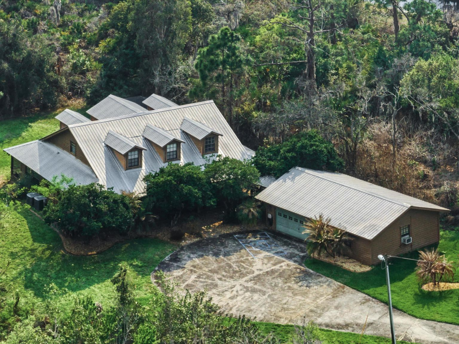 Aerial view of 665 Moon Ranch Road — a ranch home on 2 wooded acres in Sebring, Florida