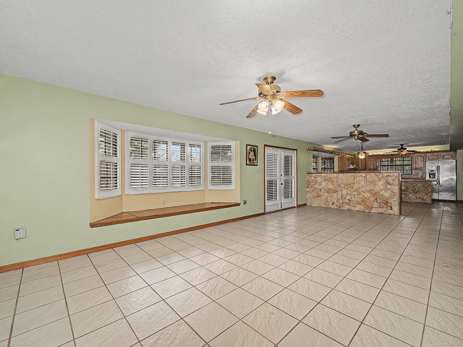 Open-plan main living and dining area with bay window