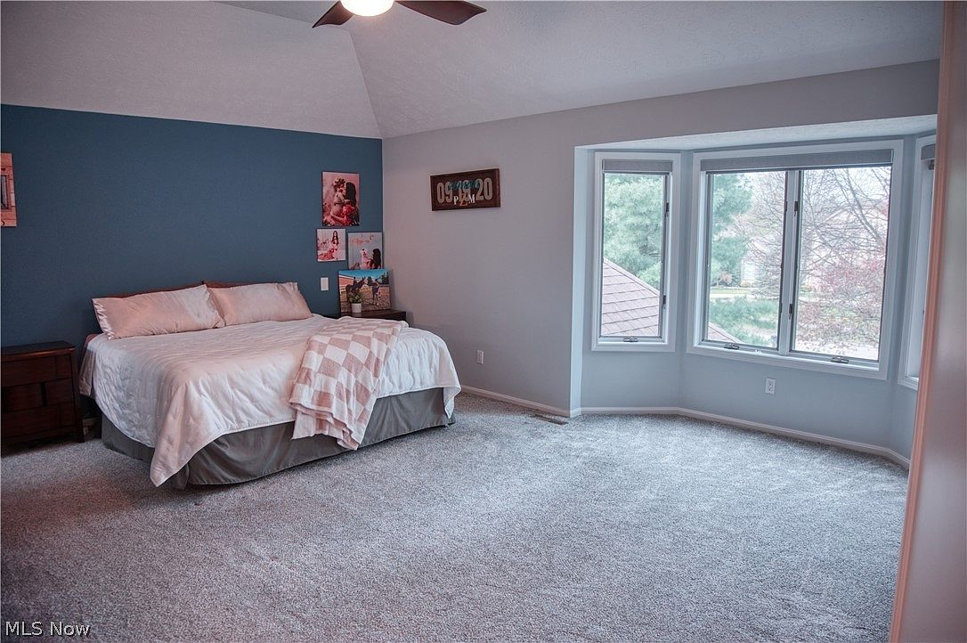 Master bedroom with vaulted ceiling and large bay window