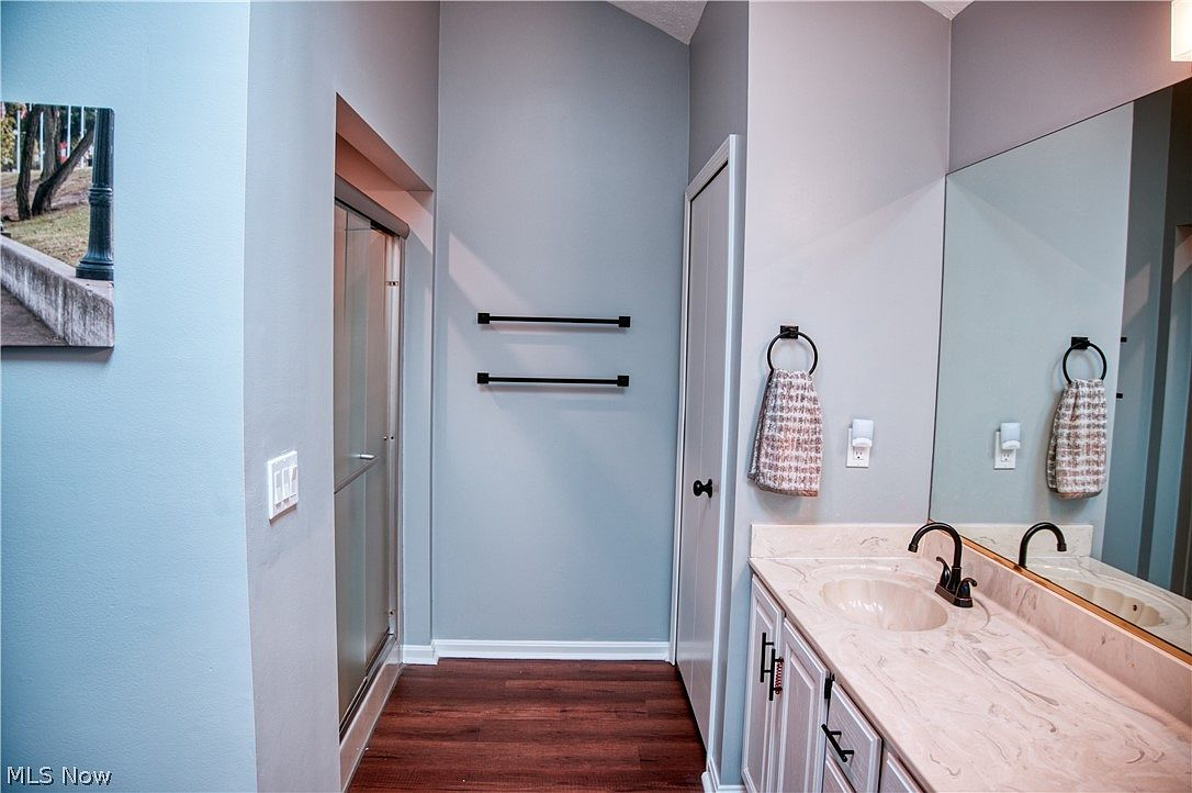 Bathroom with modern updates including light blue walls and matte black hardware