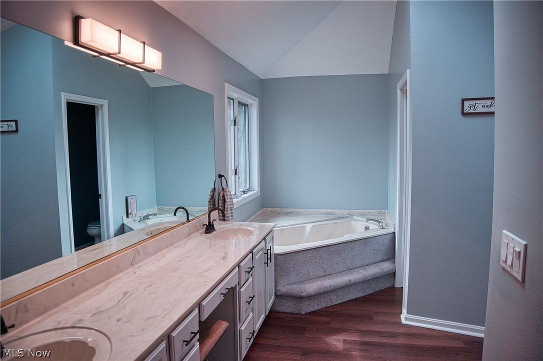 Master bathroom with soaking tub and dual sink vanity