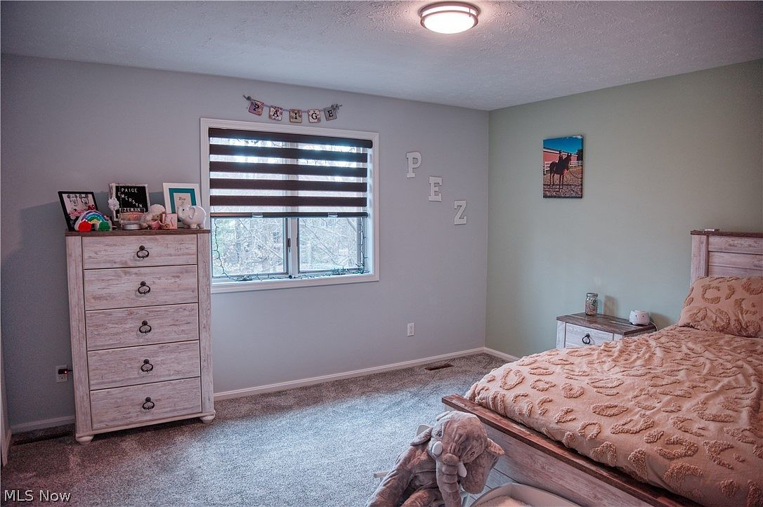 Secondary bedroom with updated neutral paint and carpet