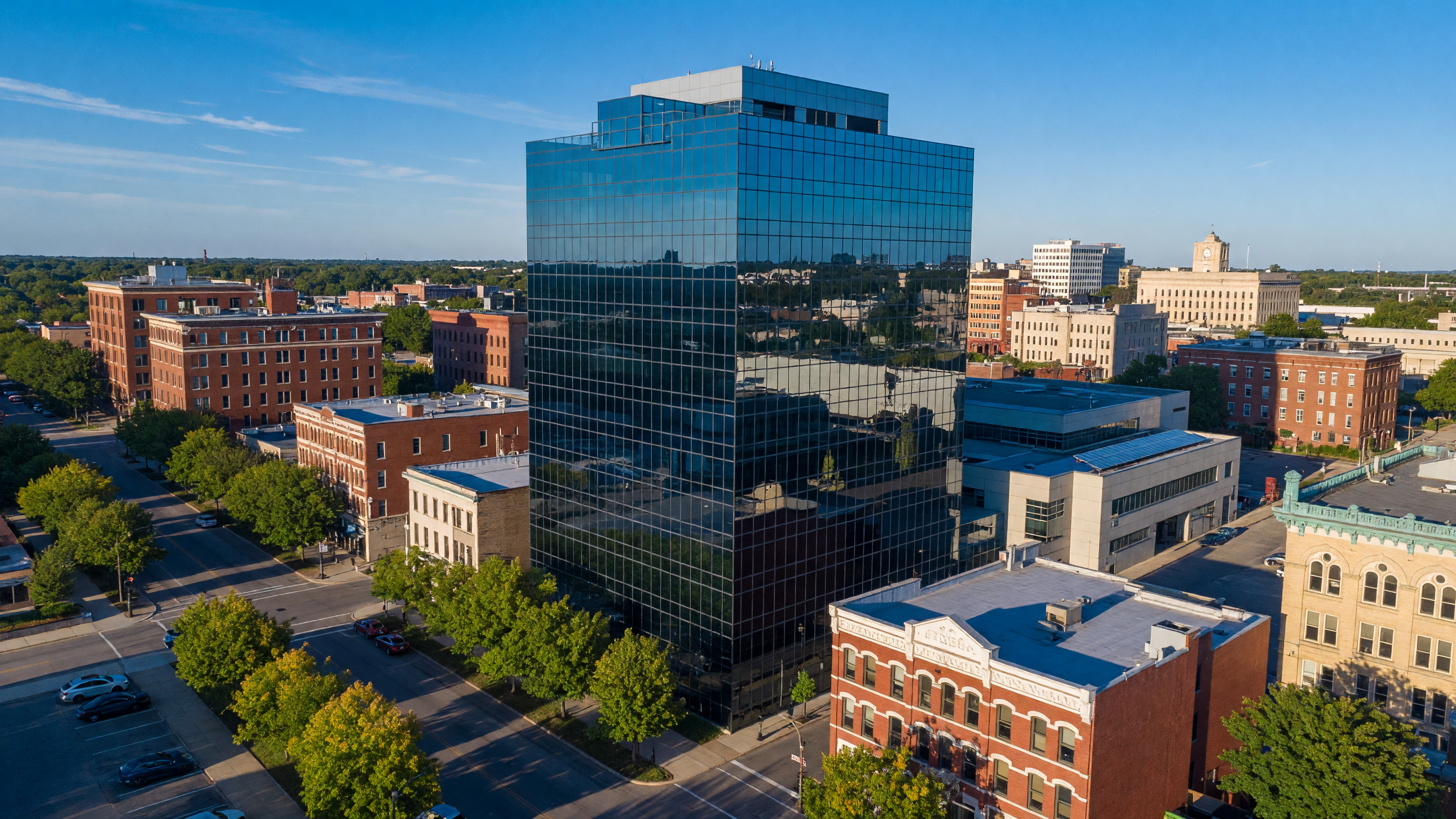 Modern glass office building reflecting blue sky in downtown Dayton Ohio