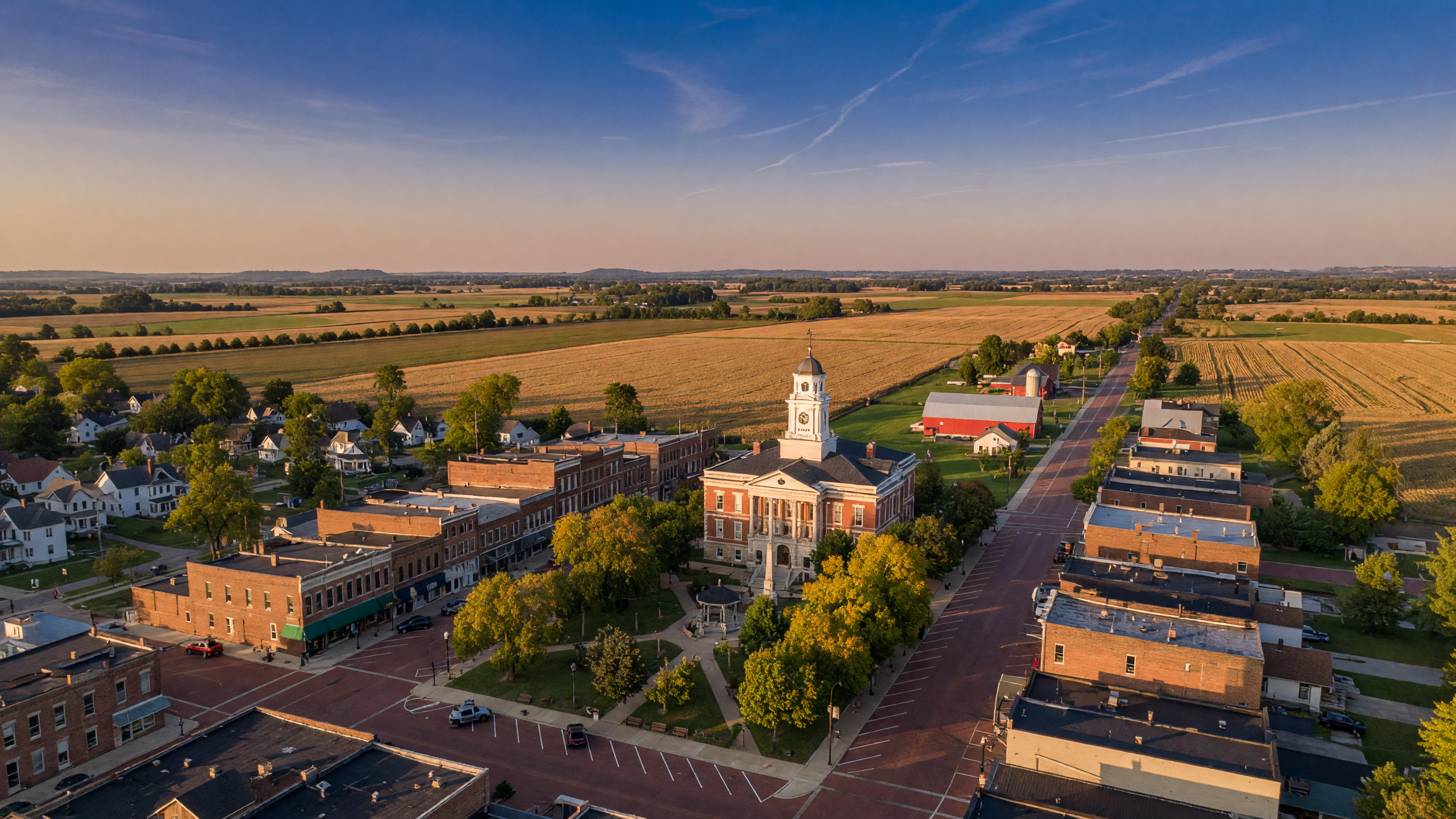 Aerial view of Troy Ohio historic town square with courthouse and surrounding Miami County farmland