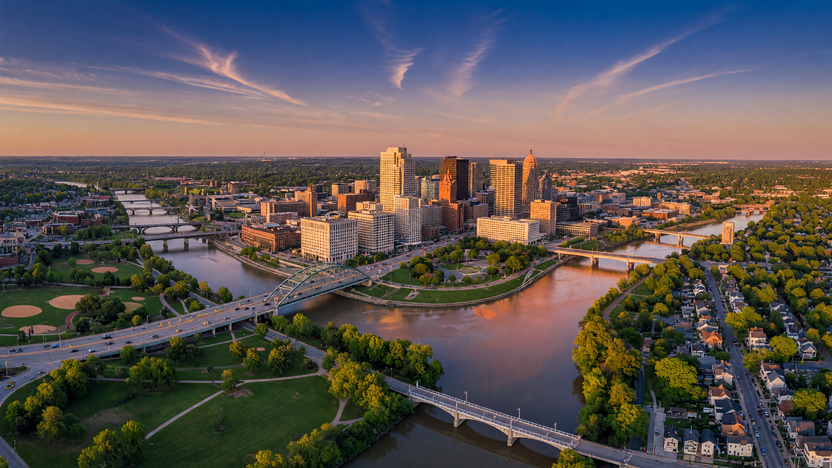 Aerial view of the Greater Dayton Ohio metro area with neighborhoods, tree-lined streets, and suburban communities stretching across the Miami Valley