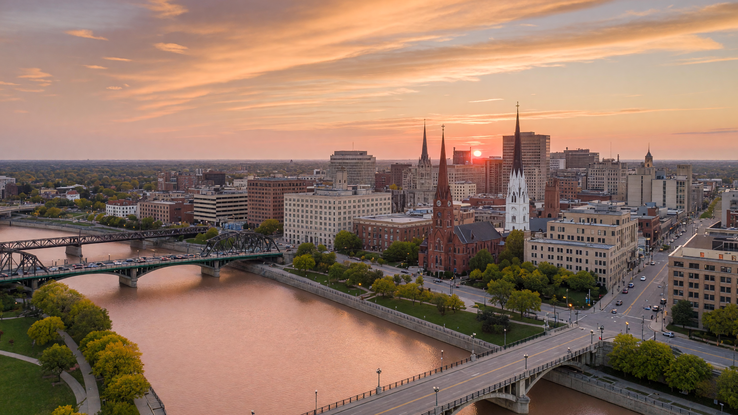 Golden hour aerial view of downtown Dayton, Ohio cityscape with the Great Miami River and bridges