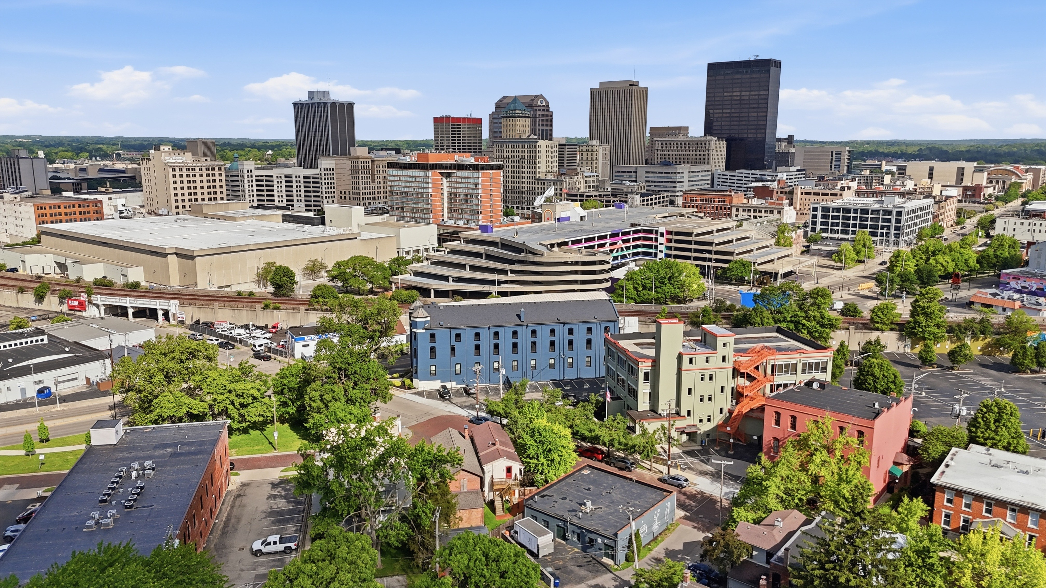 Aerial view of the Cincinnati skyline with surrounding neighborhoods on a clear day
