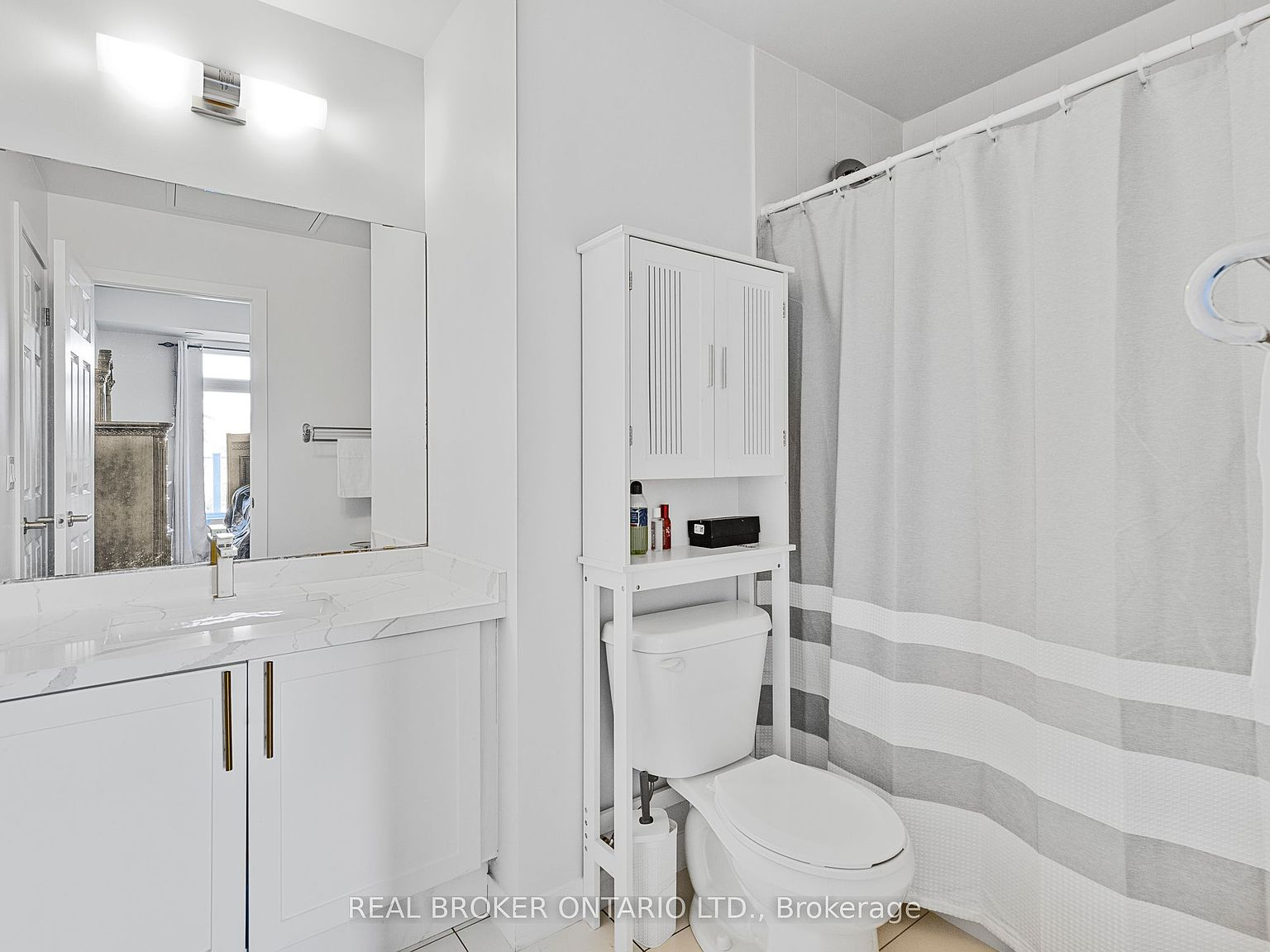 Modern bathroom with white vanity and gold hardware